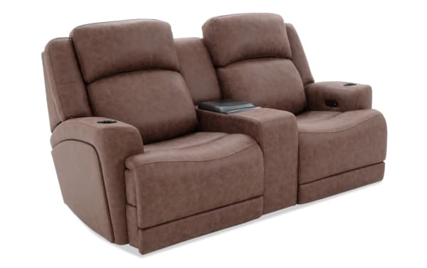 Brown leather reclining loveseat with cup holders, padded armrests, and center console, designed for home theater seating comfort.
