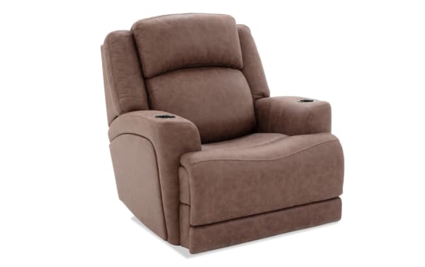 Brown leather recliner chair with padded armrests, built-in cup holders, and cushioned backrest for living room comfort.
