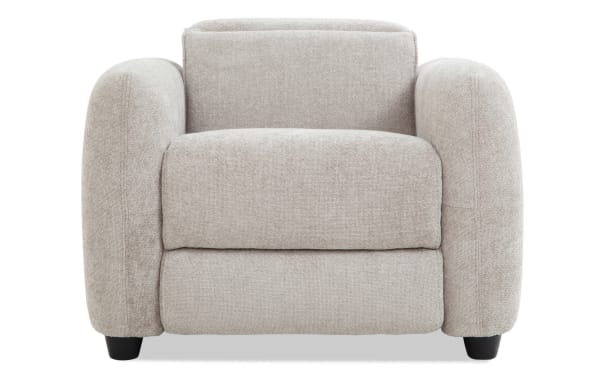 Beige upholstered armchair with thick padded cushions, rounded armrests, and black wooden legs, suitable for modern living room seating.