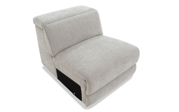 Light gray upholstered armless lounge chair with soft fabric, thick cushioned seat, and angled backrest for modern living room seating.