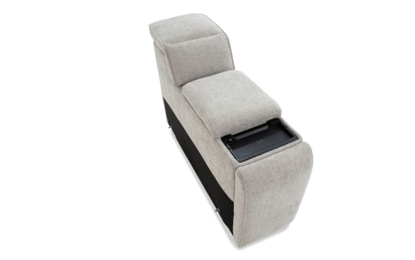 Light gray fabric sofa armrest with built-in wireless charging pad, featuring cushioned top and black side panel for modern living room furniture.
