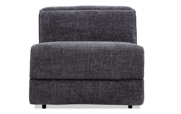 Dark gray upholstered armless accent chair with a textured fabric, cushioned seat and backrest, modern minimalist design.