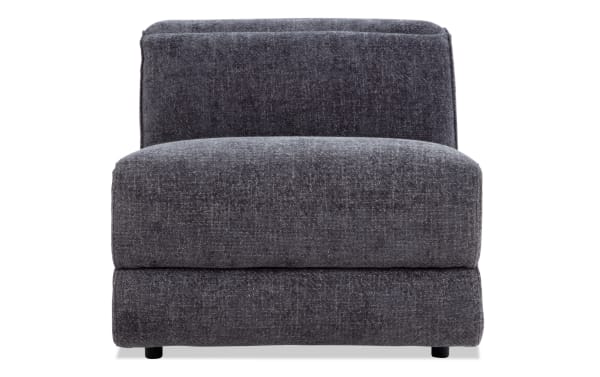 Modern armless accent chair upholstered in dark gray textured fabric with a thick cushioned seat and backrest, ideal for contemporary living spaces.