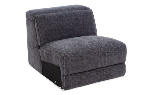 Dark gray upholstered armless chair with plush cushioning and textured fabric, designed for modern living room seating.