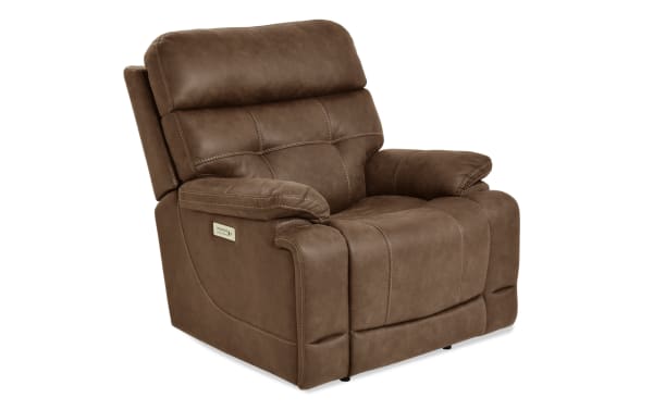 Brown leather recliner chair with plush cushioning, padded armrests, and visible stitching, featuring a side control panel for reclining adjustment.
