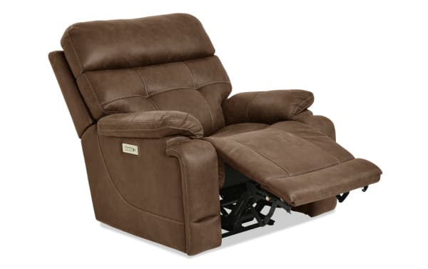 Brown microfiber recliner chair with padded armrests, cushioned backrest, and extended footrest, featuring a side control panel for reclining adjustment.