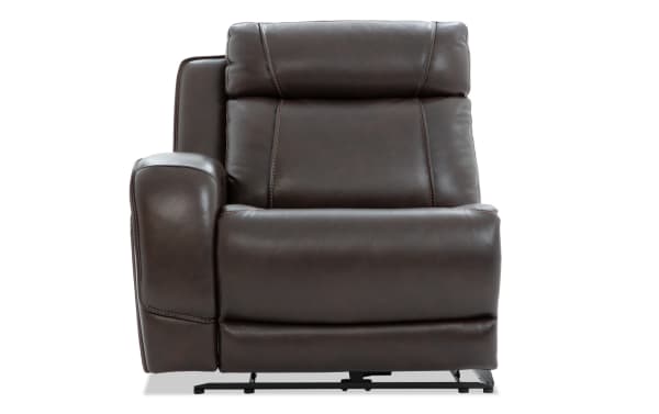 Dark brown leather recliner chair with padded armrest, cushioned backrest, and visible stitching, designed for comfort and relaxation.