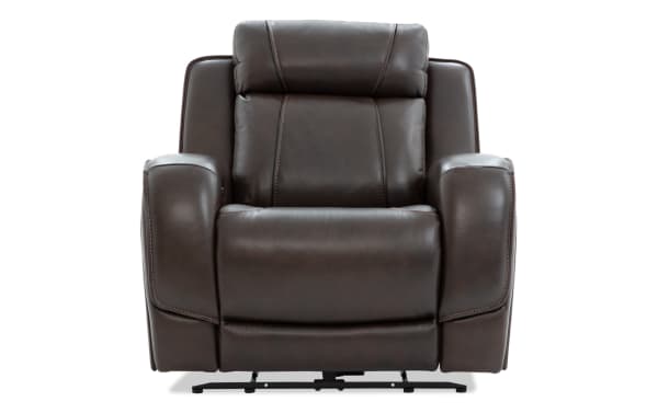 Dark brown leather recliner chair with cushioned armrests, padded backrest, and visible stitching, designed for comfort and style.