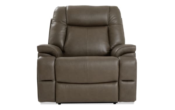 Brown leather recliner chair with padded armrests and cushioned backrest, designed for comfort and relaxation in living rooms.