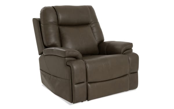 Dark brown leather recliner chair with plush cushioning, padded armrests, and stitched detailing, designed for living room comfort and style.