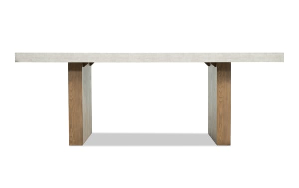 Rectangular dining table with a light gray concrete top and sturdy brown wooden legs, modern minimalist design.