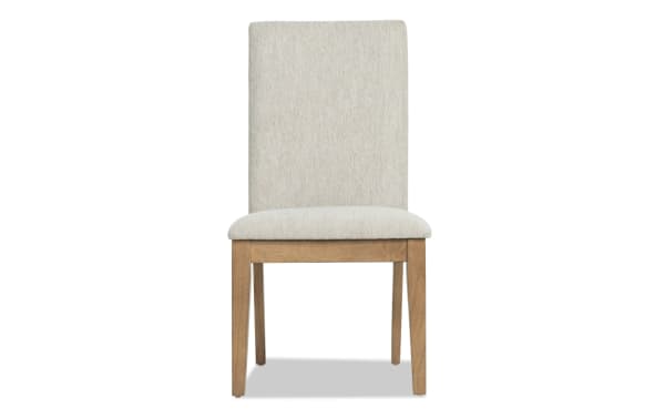 Upholstered dining chair with beige fabric seat and backrest, solid wood frame in natural finish, modern minimalist design.