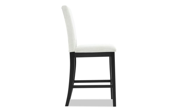 Upholstered dining chair with white fabric seat and backrest, black wooden legs, and a supportive back, suitable for modern interiors.
