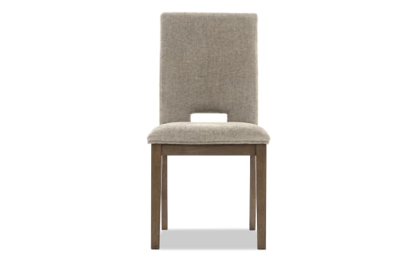 Upholstered dining chair with beige fabric seat and backrest, wooden legs, modern design, suitable for home or office seating.