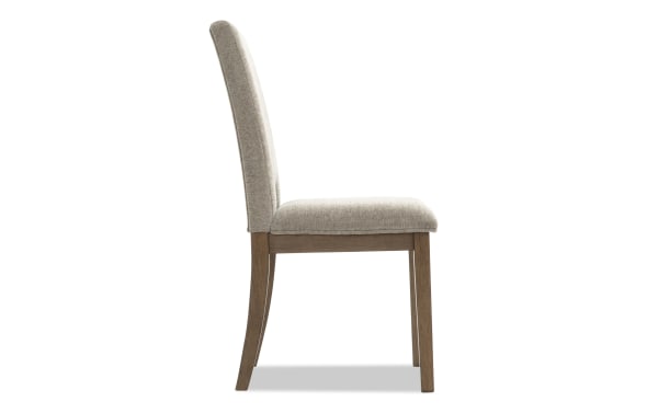 Upholstered dining chair with beige fabric seat and backrest, wooden legs in a natural finish, modern classic design.