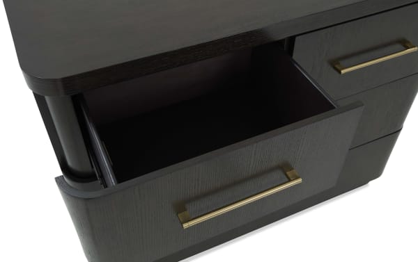 Dark wood drawer with a brass handle, partially open, showcasing smooth finish and modern design, ideal for stylish storage furniture.