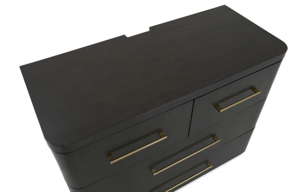 Dark wood dresser with rounded corners, featuring multiple drawers with long, slim brass handles, showcasing a modern, elegant design.