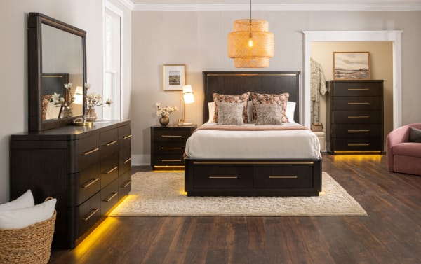 Dark wood dresser drawer open, showing smooth interior with brass handles, highlighting modern bedroom storage furniture design.