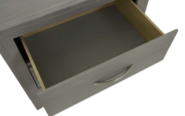 Open wooden drawer with a light gray finish and metal handle, showcasing smooth interior and modern storage design.