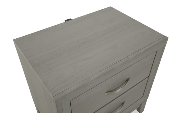 Gray wooden nightstand with two drawers featuring curved metal handles, showcasing a smooth, matte finish and modern design.
