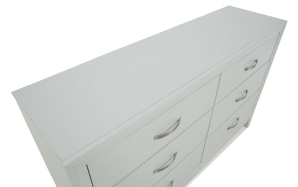 White modern dresser with six drawers and silver curved handles, featuring a smooth matte finish and clean lines for bedroom storage.