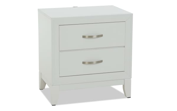 White wooden nightstand with two drawers, silver curved handles, and tapered legs, suitable for bedroom storage and decor.