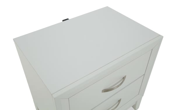 White wooden nightstand with two drawers, featuring curved silver handles and a smooth, flat top surface.