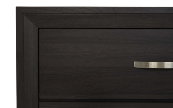 Dark brown rubberwood panel with a sleek silver drawer handle from the Trinity Brown 6 Drawer Dresser, transitional style.