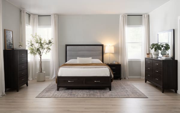 Transitional Trinity Bedroom set with dark brown rubberwood furniture, including a 5-drawer chest, dresser with mirror, nightstand, and upholstered bed with storage drawers.