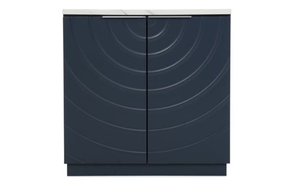 Modern navy blue kitchen base cabinet with textured concentric circle design on doors, white countertop, and silver handle bar.