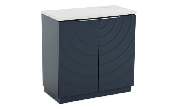 Modern navy blue bathroom vanity cabinet with textured concentric circle design, white marble countertop, and sleek silver handles.