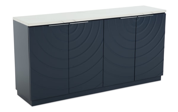 Modern navy blue storage cabinet with four doors, wave-patterned textured front, sleek metal handles, and white marble top surface.