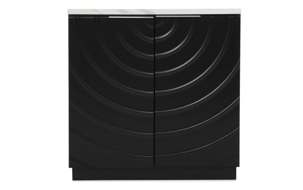 Black kitchen cabinet with a white countertop, featuring two doors with concentric circular embossed patterns and sleek silver handles.