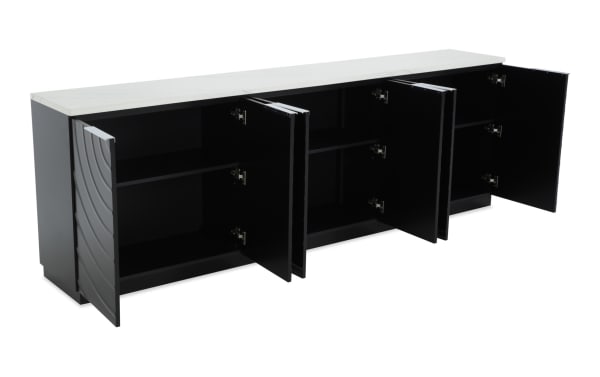 Modern black storage cabinet with four open doors, featuring a white marble top, multiple shelves, and wave-patterned side panels.