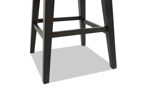 Dark wood bar stool legs with a square footrest, tapered design, and smooth finish, highlighting sturdy construction and modern style.