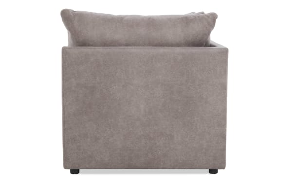 Modern taupe gray fabric armchair with plush back cushion, square design, and low black legs, suitable for living room seating.