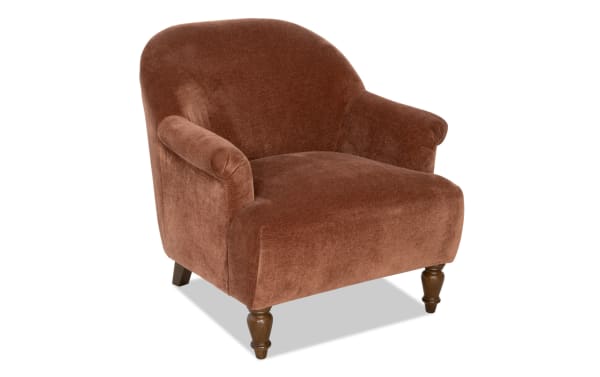 Brown velvet upholstered armchair with rounded back, rolled arms, and turned wooden legs, suitable for living room seating.