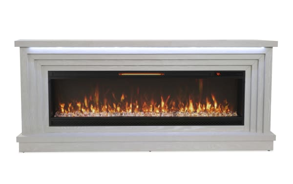 Modern electric fireplace with white wooden frame, realistic flame effect, crystal-like embers, and digital temperature display set to 72°F.