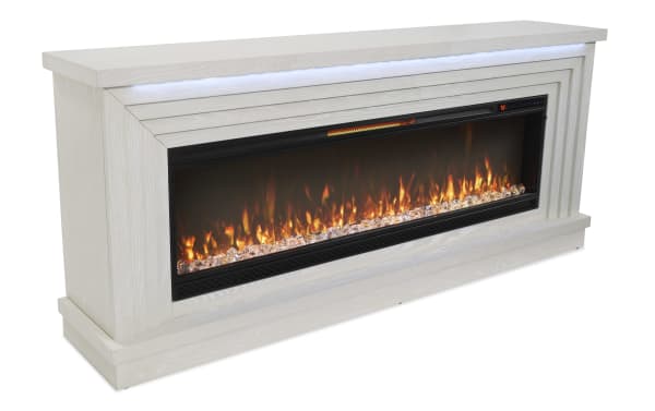 Modern electric fireplace console with white wood finish, realistic flame effect, crystal accents, and digital temperature display.