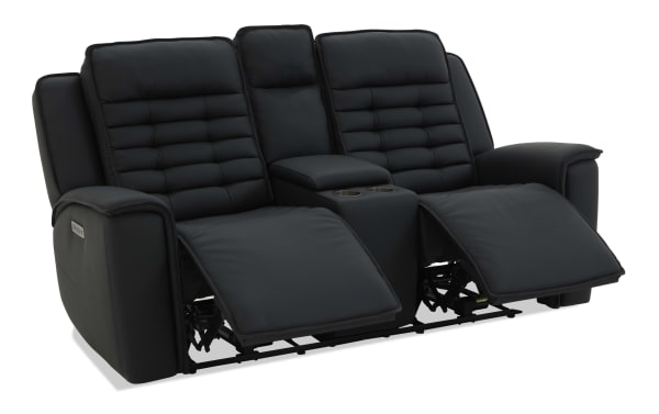 Black leather reclining loveseat with padded cushions, adjustable footrests, center console with cup holders, and plush armrests.