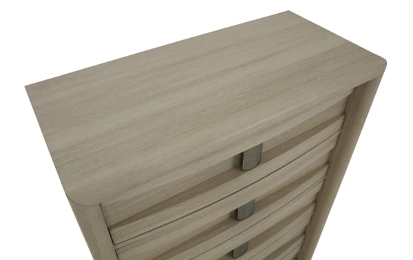 Tall wooden chest of drawers with a light oak finish and metal handles, featuring rounded edges and a smooth top surface.