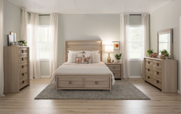 Wooden drawer chest with a light oak finish, featuring metal handles and an open bottom drawer, showcasing smooth wood grain texture.