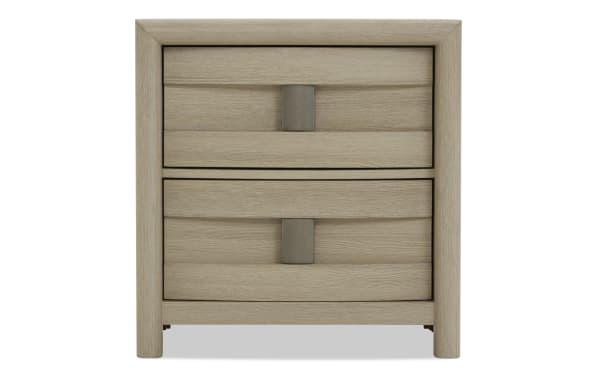 Light wood nightstand with two horizontal drawers, curved edges, and rectangular metal handles, featuring a modern minimalist design.
