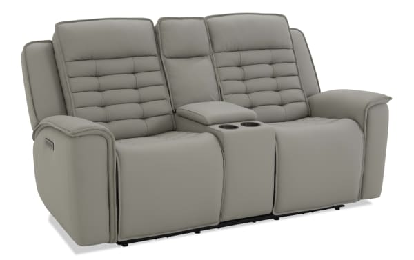 Modern gray leather reclining loveseat with padded backrests, built-in cup holders, and center console for living room comfort.
