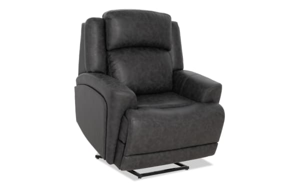 Dark gray leather recliner chair with cushioned armrests and backrest, featuring a modern lift mechanism and sturdy metal base.