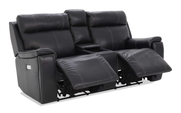 Black leather dual recliner loveseat with plush cushioning, contrast stitching, and center console with cup holders, ideal for home theater seating.