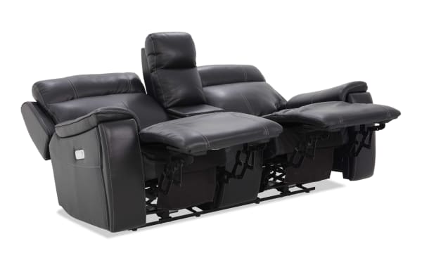 Black leather dual recliner sofa with padded armrests, adjustable footrests, and a center console with storage, ideal for living room comfort.