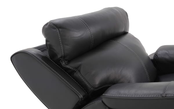 Black leather recliner chair headrest and armrest with visible white stitching, showcasing soft padded upholstery and modern design.