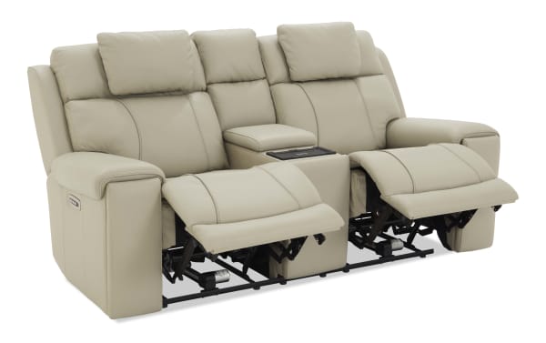Beige leather reclining loveseat with dual footrests extended, padded armrests, and center console with storage and cup holders, modern style.