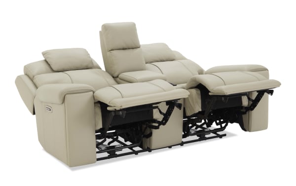 Beige leather reclining loveseat with adjustable headrests, padded armrests, and a central console, designed for comfort and relaxation.